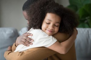 Foster child hugging foster parent